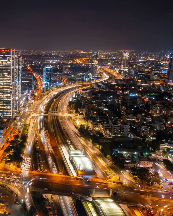 A city skyline lit up at night seen from above