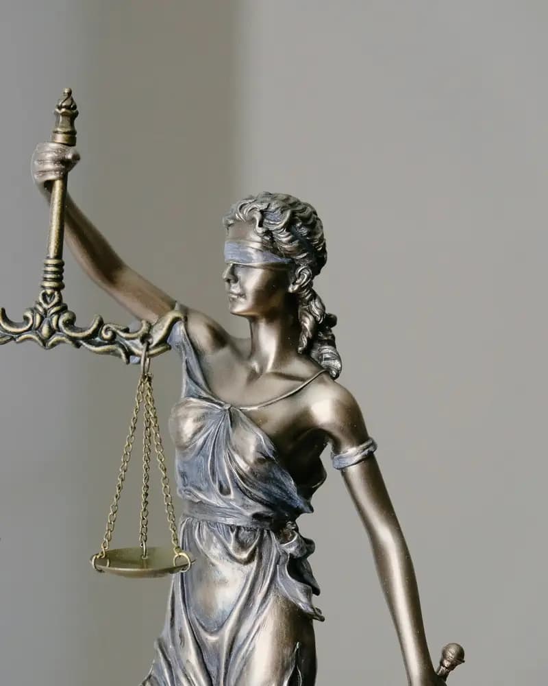 A bronze statue of Lady Justice holding scales