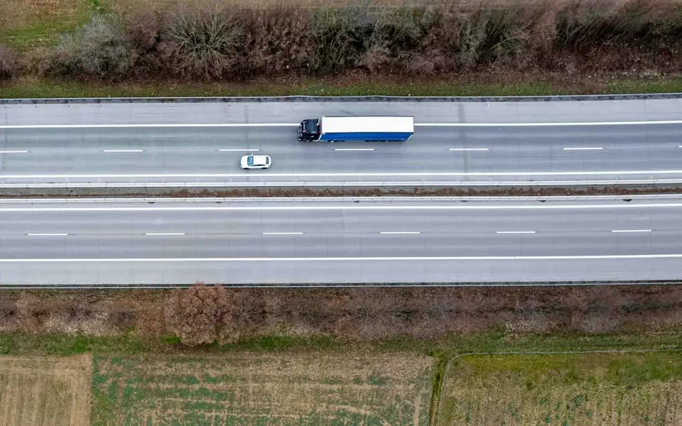 Aerial view of freight trucks driving along a motorway
