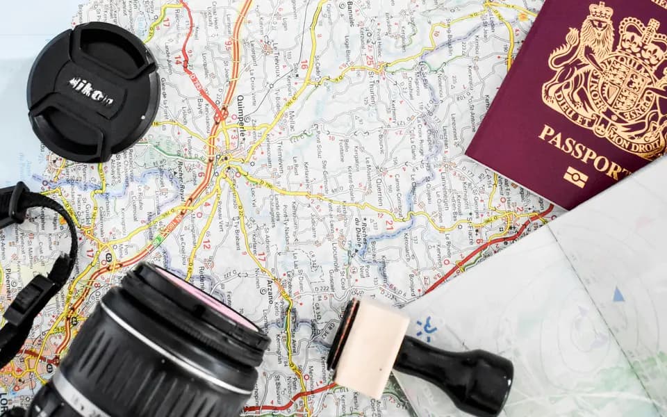Travel map with a passport, camera and postcard