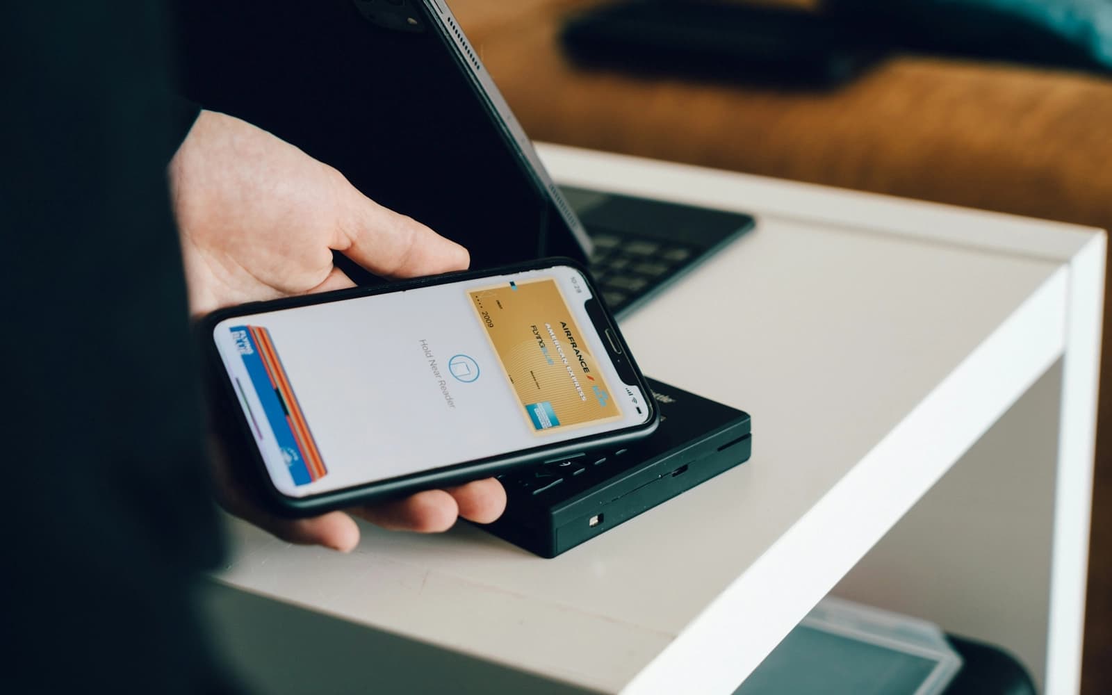 A phone being held over a contactless payment terminal