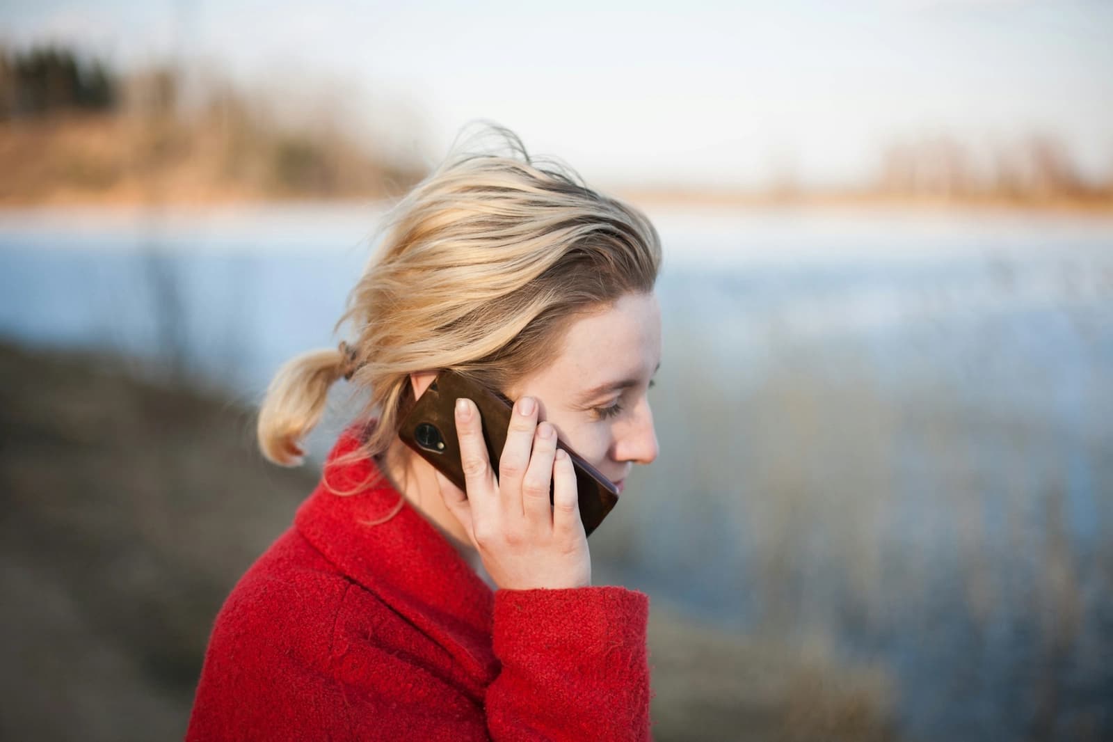 A woman taking a phone call outdoors