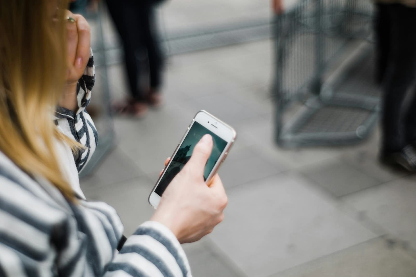 A person holding a smartphone in one hand