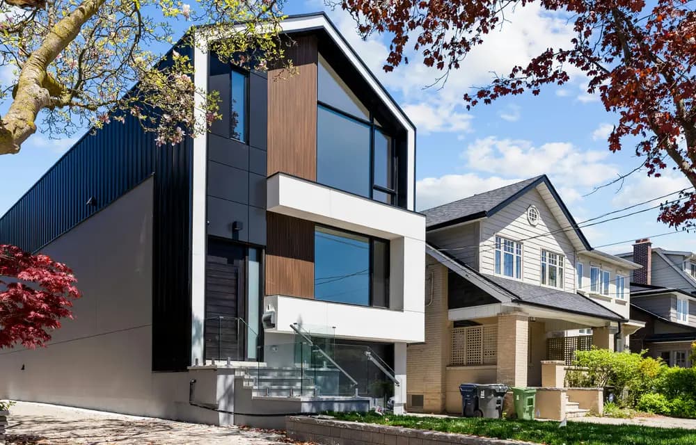 Modern houses on a residential street under a blue sky